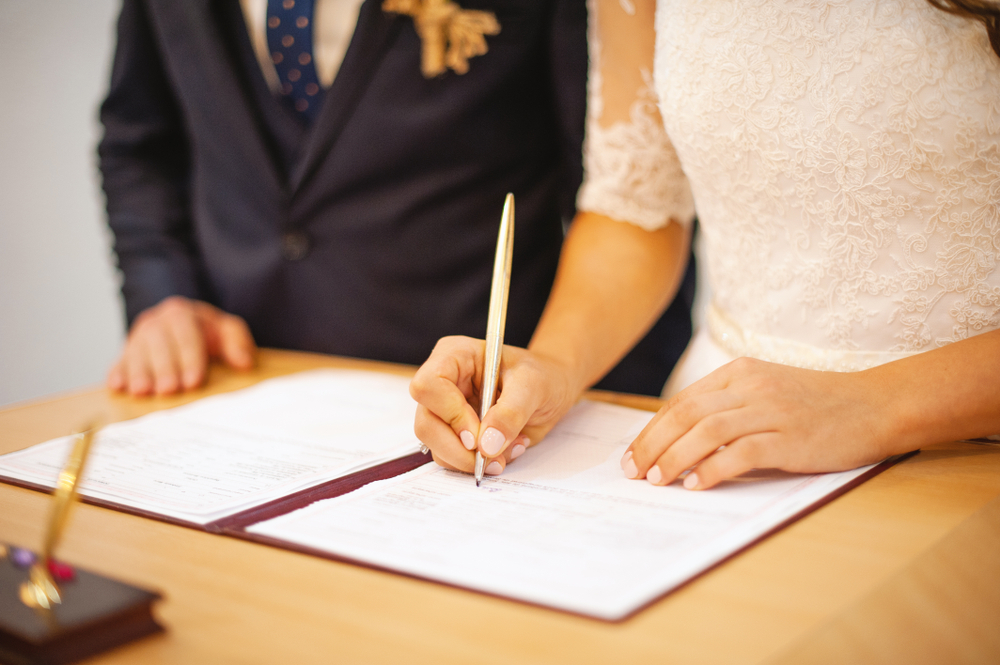 Couple signing wedding register